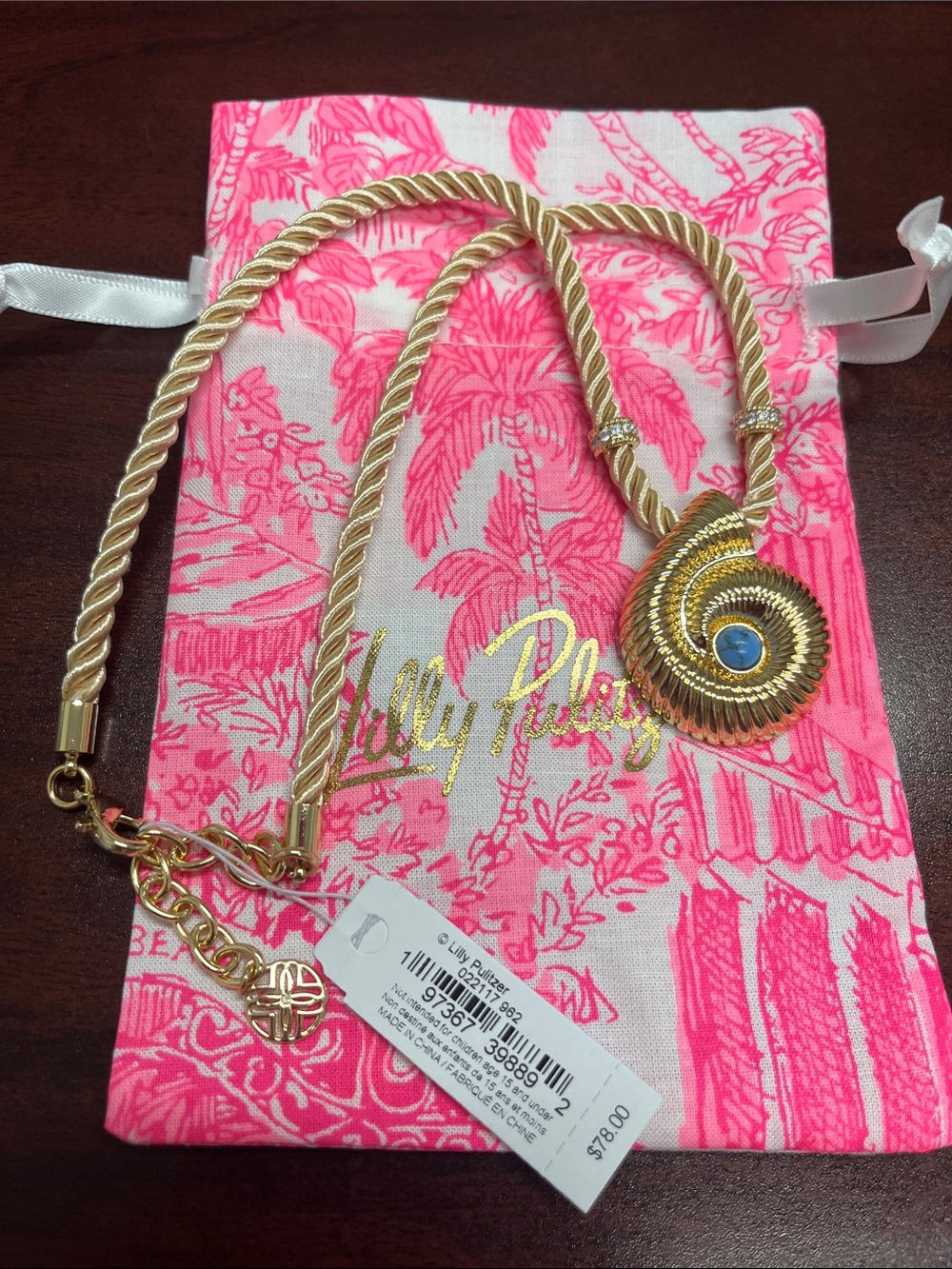Lilly Pulitzer gold shell with blue stone!  Gold cord with accents. Beautiful.